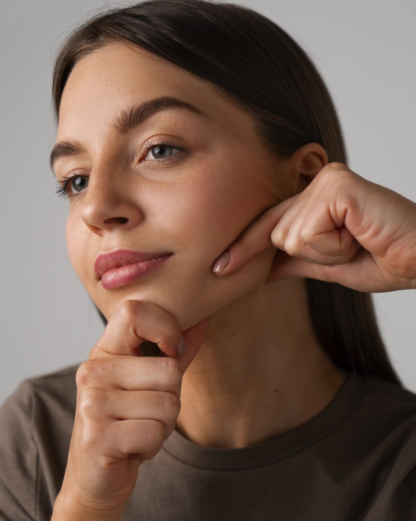side-view-woman-practicing-facial-yoga